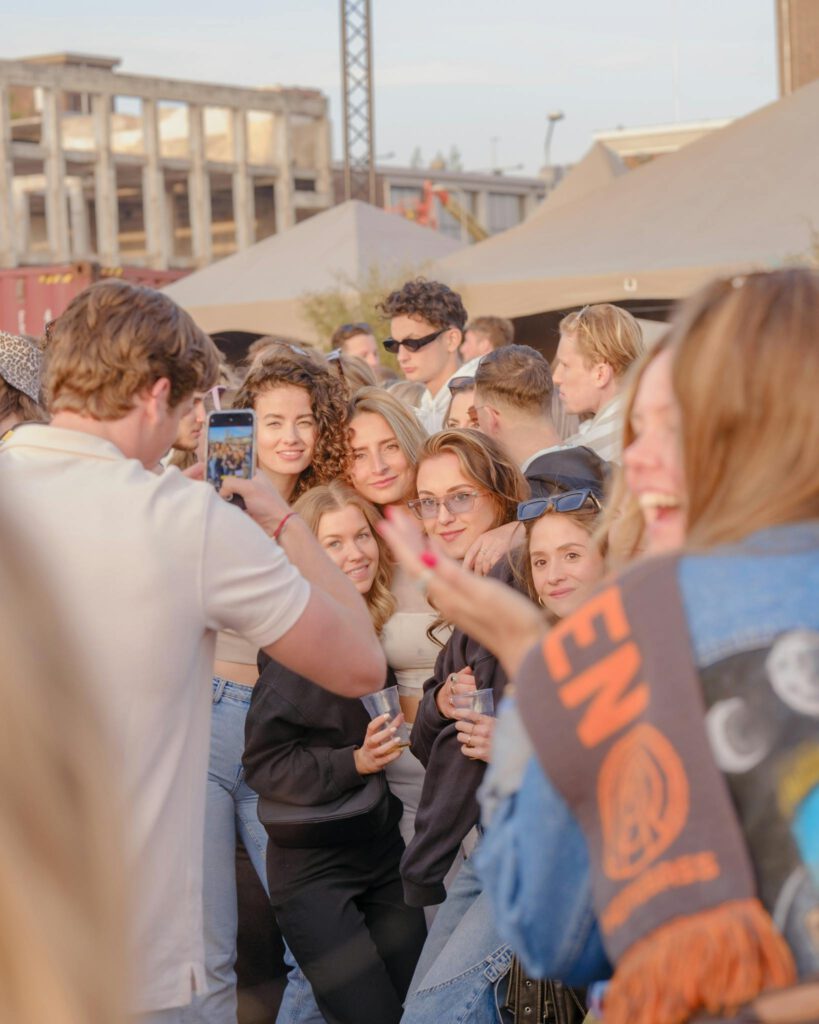 Young adults enjoying a lively outdoor festival in Nijmegen, perfect for capturing urban fun.